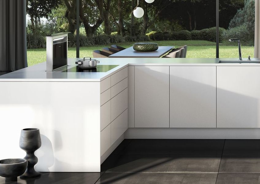 SieMatic Pure SE base cabinets in glossy lotus white SQ lacquer with downdraft extractor