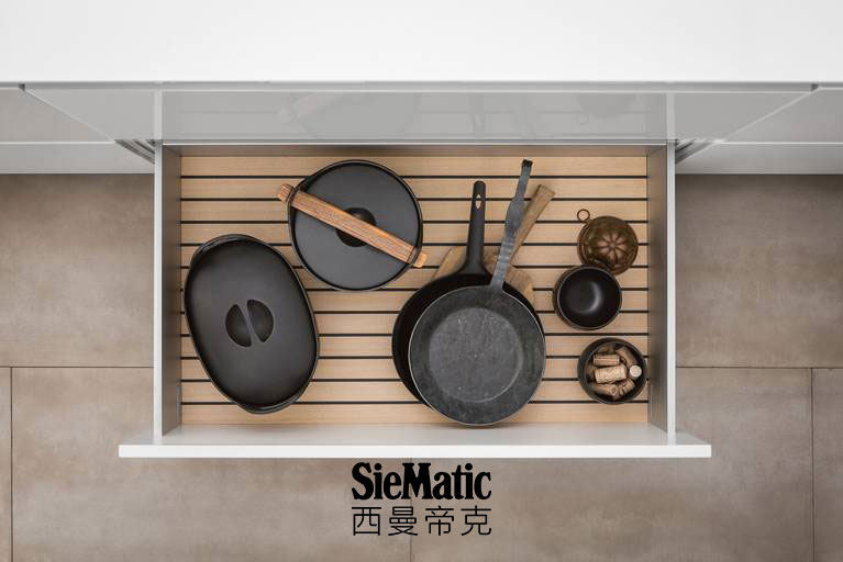 Pots and pans on GripDeck in light oak from SieMatic wooden kitchen accessories