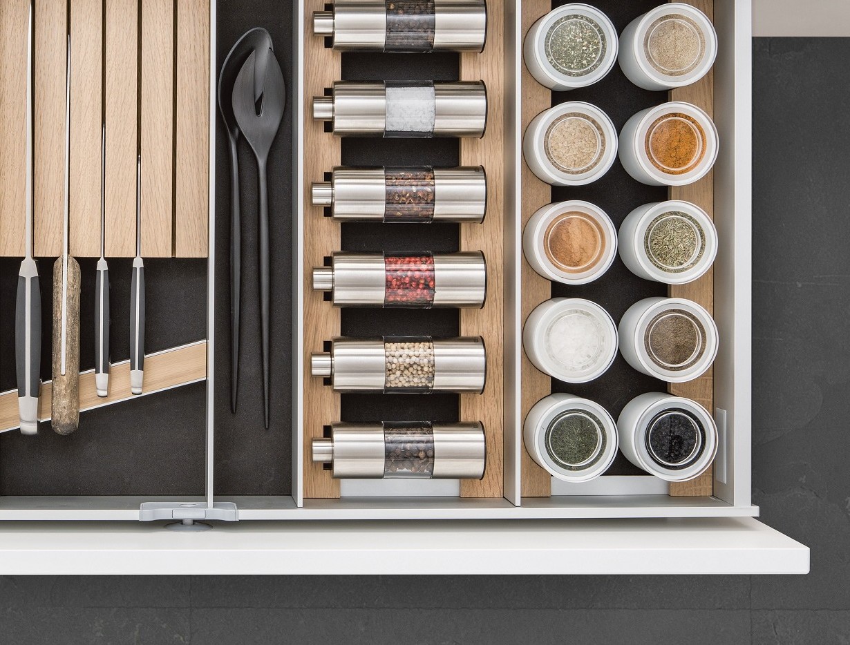 SieMatic Aluminum Interior Accessories in light oak offer space for spice mills, porcelain jars and knives.