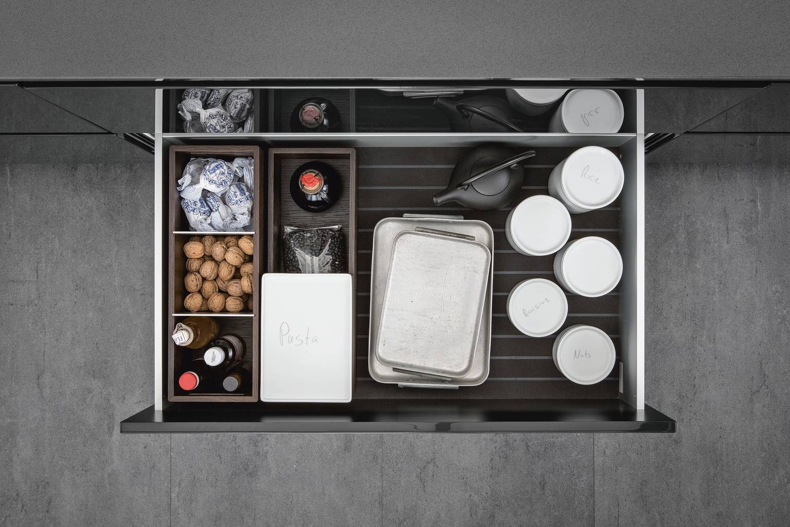 Porcelain jars and organization inserts from SieMatic Aluminum Interior Accessories System