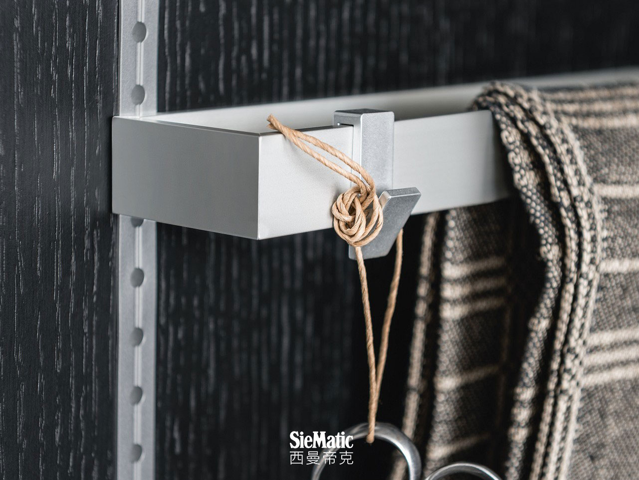 Dishcloth rack and hooks from the SieMatic MultiMatic interior organization system for kitchen cabinet doors