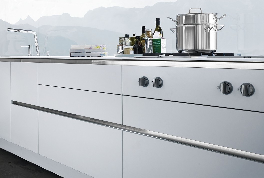 SieMatic S2 base cabinets in lotus white gloss with handle channel in the Pure style collection