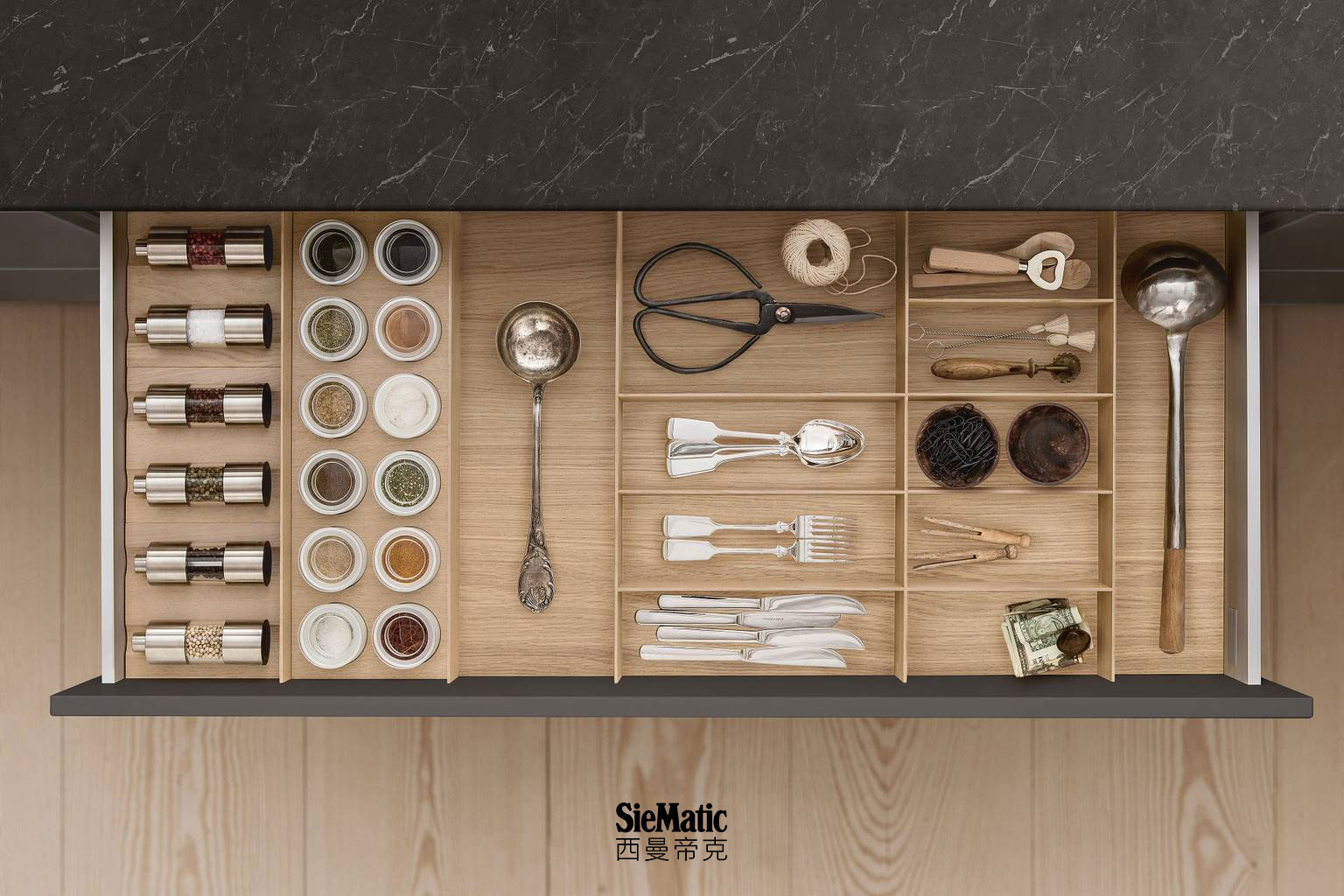 Cutlery, spice mills and porcelain jars in drawer with SieMatic kitchen interior accessories