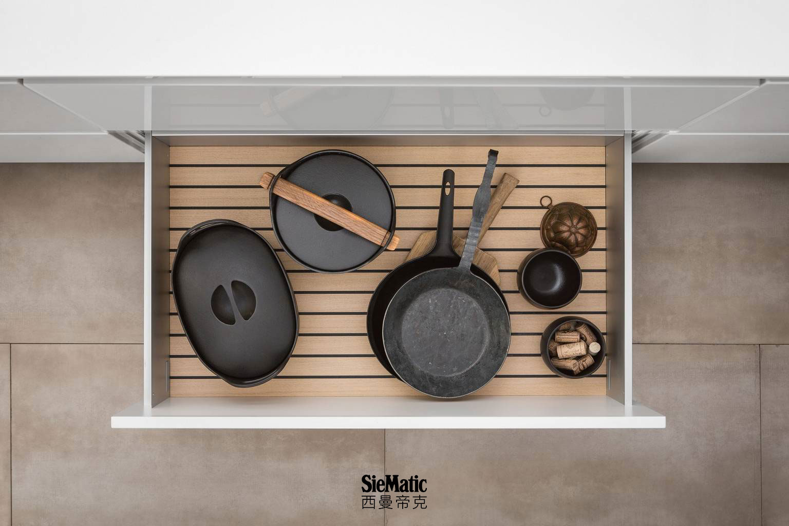 Pots and pans on GripDeck in light oak from SieMatic wooden kitchen accessories